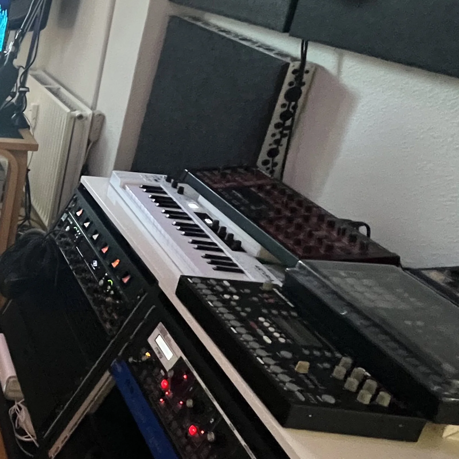 Outboard and instruments gathered in racks and on the work surface inside the Dolby Atmos studio