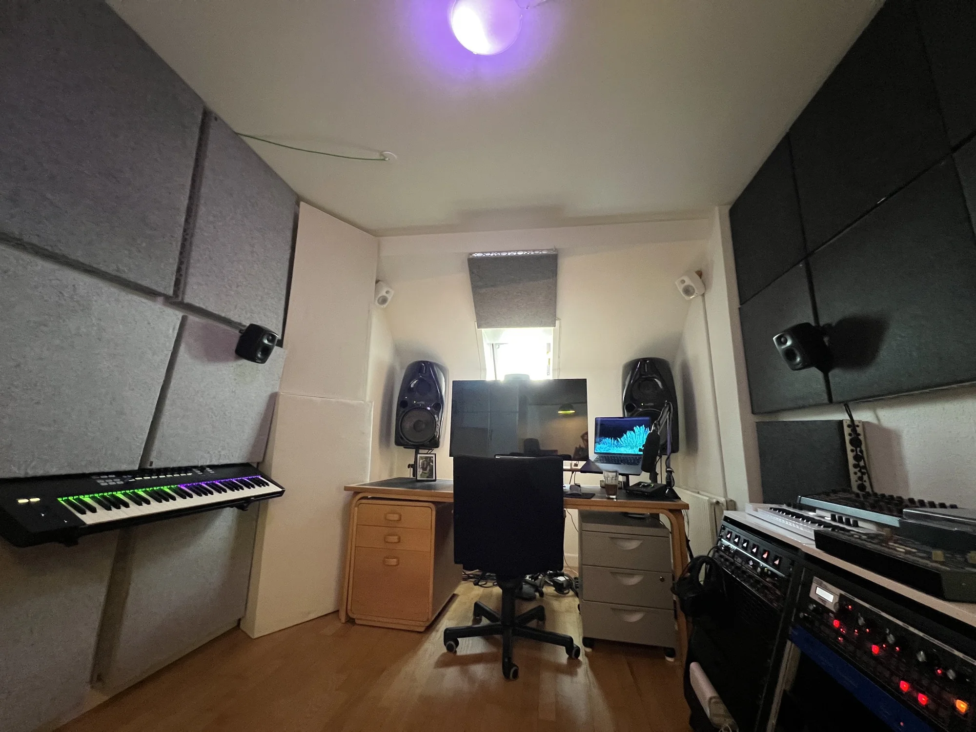 Mix position in Julius Sylvest's Dolby Atmos studio with displays, monitoring and work surface