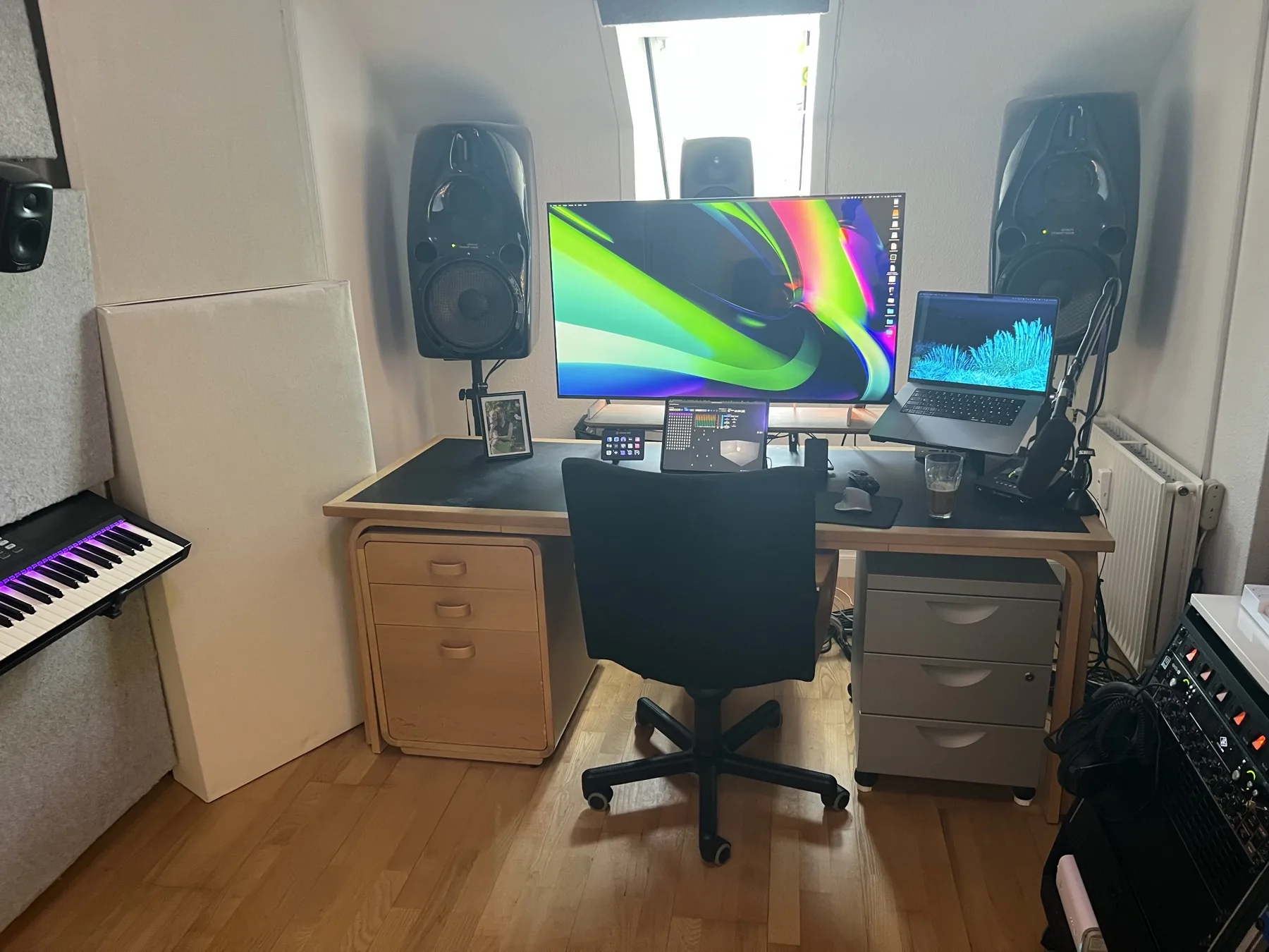 Mix position in the studio with displays, speakers and workstation for Dolby Atmos production.